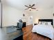 Well-lit bedroom boasts hardwood floors, ceiling fan, and comfortable furniture at 14234 Desert Haven St # 14234, Windermere, FL 34786