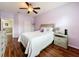 Cozy bedroom featuring a ceiling fan, wood floors, and access to closet at 14234 Desert Haven St # 14234, Windermere, FL 34786