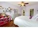 Bright bedroom boasts wood floors, ceiling fan, shelves, and pink decorations at 14234 Desert Haven St # 14234, Windermere, FL 34786