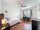 Cozy bedroom offers wood floors, a ceiling fan, and natural light from the window at 14234 Desert Haven St # 14234, Windermere, FL 34786