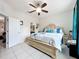 Well-lit bedroom featuring tile floors, a ceiling fan, and a bed with decorative pillows at 14234 Desert Haven St # 14234, Windermere, FL 34786