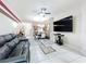 Inviting living room boasts a ceiling fan, tile flooring, and a comfortable leather sofa at 14234 Desert Haven St # 14234, Windermere, FL 34786