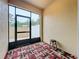 Enclosed patio with patterned carpet and a stool at 14234 Desert Haven St # 14234, Windermere, FL 34786