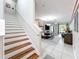 Staircase with wood steps and white risers leading to an open-concept living and dining area at 14234 Desert Haven St # 14234, Windermere, FL 34786