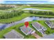 Aerial shot of a home near a tranquil pond, complemented by highway and scenic greenery in the background at 159 Olympus Way, Kissimmee, FL 34759
