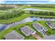Drone shot of a home near a tranquil pond, complemented by highway and scenic greenery in the background at 159 Olympus Way, Kissimmee, FL 34759