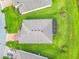 Overhead shot of home's roof and well manicured lawn, including the brick driveway at 159 Olympus Way, Kissimmee, FL 34759