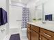 Well-lit bathroom with a shower-tub combo, a stylish vanity, and a modern mirror at 159 Olympus Way, Kissimmee, FL 34759