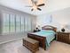 Traditional bedroom featuring light gray walls, plantation shutters, and a decorative shell art piece at 159 Olympus Way, Kissimmee, FL 34759