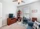 Bedroom with a television, ceiling fan, and a desk with a chair at 159 Olympus Way, Kissimmee, FL 34759