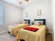 Bright bedroom featuring two beds, neutral walls, and ample natural light from a window at 159 Olympus Way, Kissimmee, FL 34759