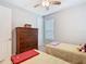 Cozy bedroom with two twin beds, a dresser, and a ceiling fan at 159 Olympus Way, Kissimmee, FL 34759