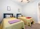 Bright bedroom featuring two beds, neutral walls, and ample natural light at 159 Olympus Way, Kissimmee, FL 34759