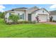 Well-maintained home featuring manicured landscaping and a charming combination of stone and stucco exterior at 159 Olympus Way, Kissimmee, FL 34759