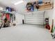 Spacious garage with epoxy flooring and overhead storage racks at 159 Olympus Way, Kissimmee, FL 34759