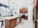 Open concept kitchen with large island, stainless appliances, and seamless connection to the living area at 159 Olympus Way, Kissimmee, FL 34759