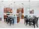 Well-lit kitchen provides ample counter space, seating, and seamlessly connects to the dining area for easy entertaining at 159 Olympus Way, Kissimmee, FL 34759