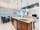 Open kitchen features a center island, stainless appliances, granite countertops and views of the living areas at 159 Olympus Way, Kissimmee, FL 34759