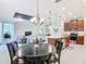 Open kitchen showcases island seating, stainless appliances, and is connected to the living and dining areas at 159 Olympus Way, Kissimmee, FL 34759