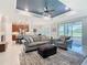 Bright, open-concept living room boasts modern finishes and plenty of natural light with a view to the golf course at 159 Olympus Way, Kissimmee, FL 34759