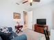 Comfortable living room featuring a cozy sofa, stylish furnishings, and a ceiling fan at 159 Olympus Way, Kissimmee, FL 34759