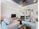 Inviting living room with comfortable seating, a sleek entertainment center and lots of natural light at 159 Olympus Way, Kissimmee, FL 34759