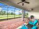 Relax on this screened patio with brick floors, ceiling fans, and peaceful views of the pond at 159 Olympus Way, Kissimmee, FL 34759
