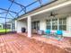 The spacious patio features brick flooring, a screened enclosure, and a ceiling fan at 159 Olympus Way, Kissimmee, FL 34759