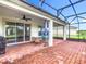 Outdoor patio with screened enclosure, ceiling fan, brick floors and beautiful views at 159 Olympus Way, Kissimmee, FL 34759