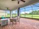 This screened lanai with brick floors has a ceiling fan and lovely water views at 159 Olympus Way, Kissimmee, FL 34759