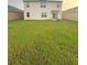 Spacious backyard with a large grass lawn, perfect for outdoor activities and entertaining at 1591 Barberry Dr, Kissimmee, FL 34744