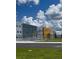 Modern school building with a bike rack, walkway, and a vibrant blue sky at 1591 Barberry Dr, Kissimmee, FL 34744