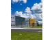 Modern school building with a bike rack, walkway, and a vibrant blue sky at 1591 Barberry Dr, Kissimmee, FL 34744
