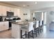 Modern kitchen featuring white cabinets, stainless steel appliances, and a granite countertop island at 1591 Barberry Dr, Kissimmee, FL 34744