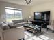 Elegant living room with comfortable seating, large window, and entertainment center with flat screen TV at 1591 Barberry Dr, Kissimmee, FL 34744