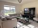 Elegant living room with comfortable seating, large window, and entertainment center with flat screen TV at 1591 Barberry Dr, Kissimmee, FL 34744