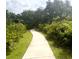 Scenic walking path winding through lush greenery, perfect for peaceful strolls and exercise at 1591 Barberry Dr, Kissimmee, FL 34744