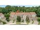 Aerial view of a row of townhomes featuring a well-maintained community with tile roofs and lush green surroundings at 196 Canterbury Bell Dr, Oviedo, FL 32765