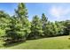 Lush green backyard with mature trees and a pond view, perfect for nature lovers at 196 Canterbury Bell Dr, Oviedo, FL 32765