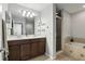 Spacious bathroom featuring double sinks, a large mirror, and a separate shower and tub at 196 Canterbury Bell Dr, Oviedo, FL 32765