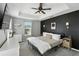 Primary bedroom with tray ceiling, accent wall, and modern décor at 196 Canterbury Bell Dr, Oviedo, FL 32765