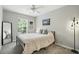 Comfortable bedroom featuring a queen-sized bed, modern fan, and light gray walls at 196 Canterbury Bell Dr, Oviedo, FL 32765