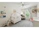 Bright Bedroom featuring a crib, rocking chair, natural light, and playful decor at 196 Canterbury Bell Dr, Oviedo, FL 32765