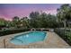 Inviting community pool with lounge chairs and evening atmosphere with lush landscaping at 196 Canterbury Bell Dr, Oviedo, FL 32765