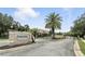 Community entrance sign with palm trees, gated entry, and lush landscaping for a welcoming feel at 196 Canterbury Bell Dr, Oviedo, FL 32765
