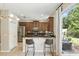 Kitchen with dark wood cabinets, stainless steel appliances, and a breakfast bar with outdoor views at 196 Canterbury Bell Dr, Oviedo, FL 32765