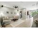 Bright living room featuring tile floors, comfortable seating, and an open layout flowing into the kitchen and dining area at 196 Canterbury Bell Dr, Oviedo, FL 32765