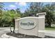 Close-up of the community entrance sign with manicured landscaping, and a stately design at 196 Canterbury Bell Dr, Oviedo, FL 32765