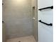 Updated bathroom featuring a tiled shower with black hardware and a built in shelf at 202 Bromwich Dr, Kissimmee, FL 34758