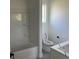 Clean bathroom featuring a bathtub and toilet, with white fixtures and neutral tones at 202 Bromwich Dr, Kissimmee, FL 34758